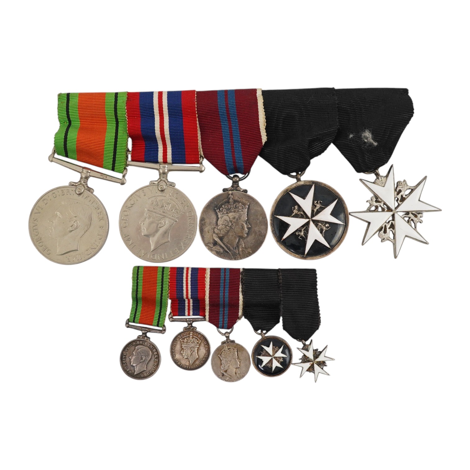 A WWII and later medal group of five medals, together with its miniature set, comprising; The Defence Medal, the 1939-1945 medal, the ERII Coronation medal, and two St. John’s Ambulance Service medals. Condition - fair t